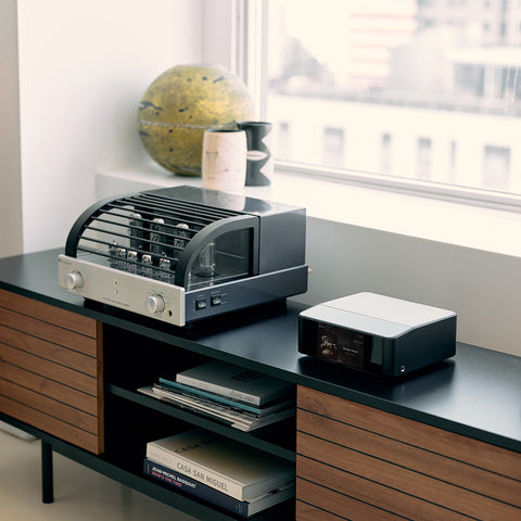 Bluesound Node Icon on a credenza beside a tube amplifier