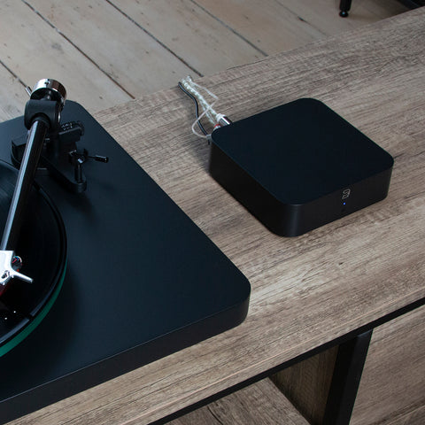Bluesound Hub on credenza beside NAD Turntable
