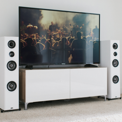 PSB Imagine T54 White beside a TV in a living room
