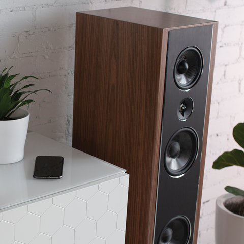 PSB Synchrony T600 satin walnut tower speaker beside white credenza - close up