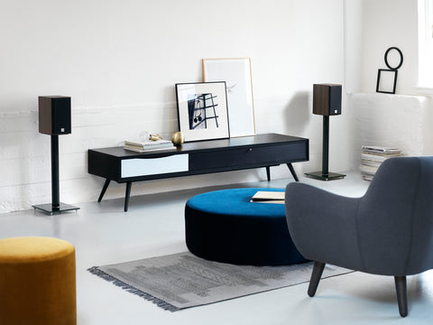 DALI Spektor 1 Walnut on speaker stands on either end of a credenza