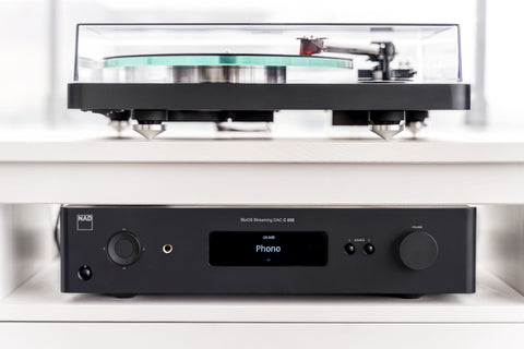 NAD C658 Music Streamer  with NAD turntable on an entertainment stand