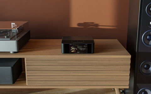 Bluesound Node ICON on table in a modern audio setup
