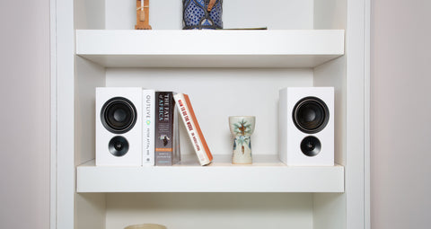 PSB Alpha iQ white on bookshelf