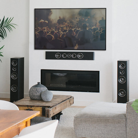 PSB Imagine T54 Tower speakers black with PSB PWM2 Black as a center channel mounted below a TV in a living room