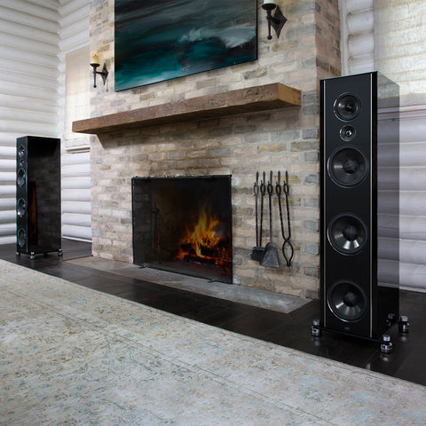 PSB Synchrony T800 Tower Speakers in a living room with a fireplace in between them