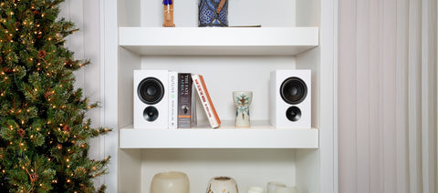 PSB Alpha iQ white on bookshelf